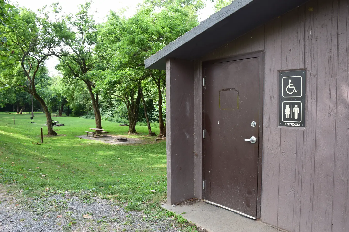 Vault Toilet and Campsite in background